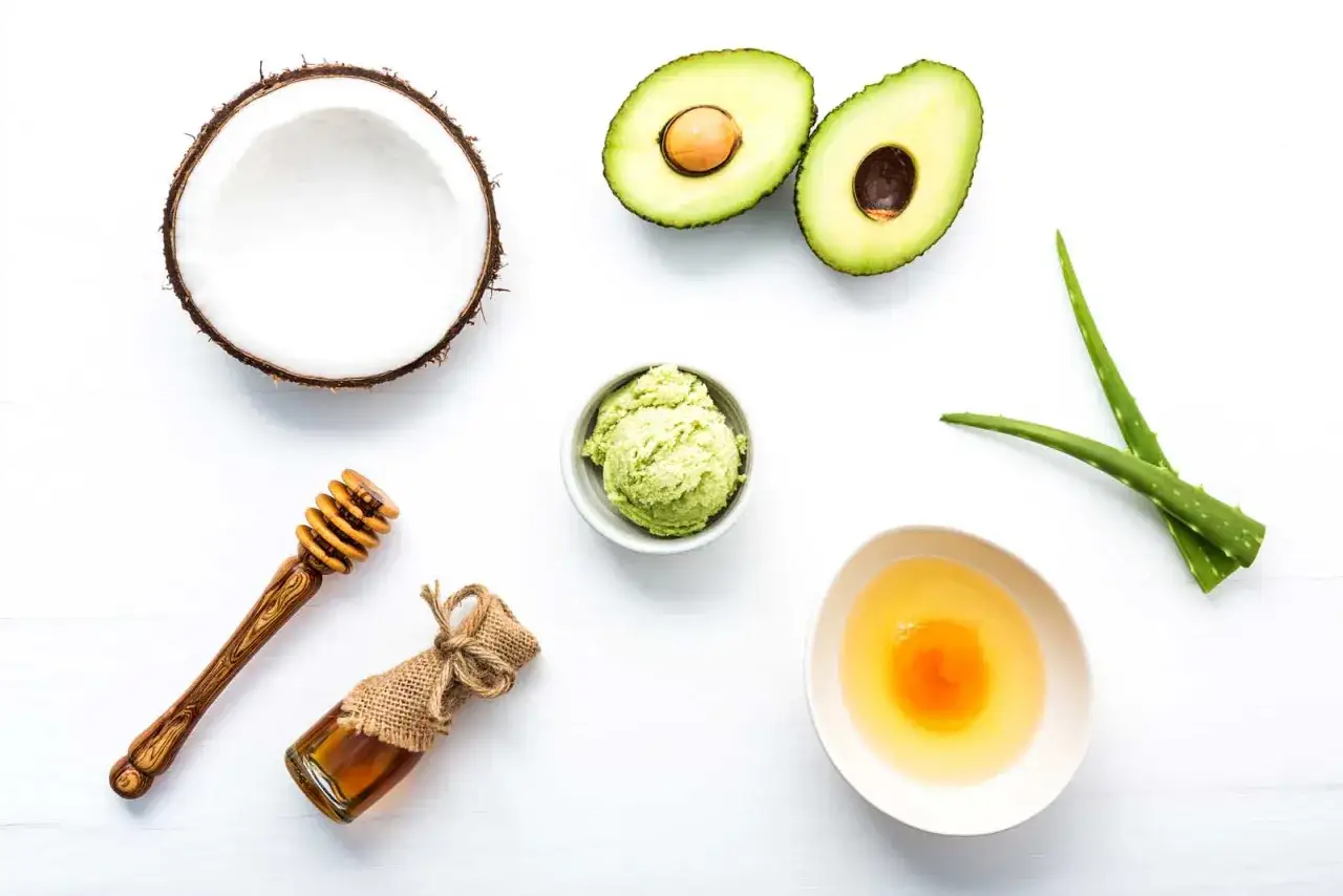 Ingredientes para una mascarilla casera para el pelo: coco, aguacate, aloe vera, miel y huevo.